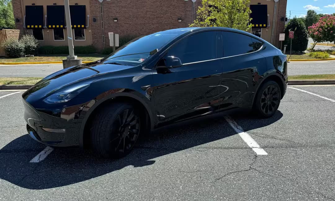 2023 Tesla Model Y Long Range AWD in Solid Black — Side Rear
