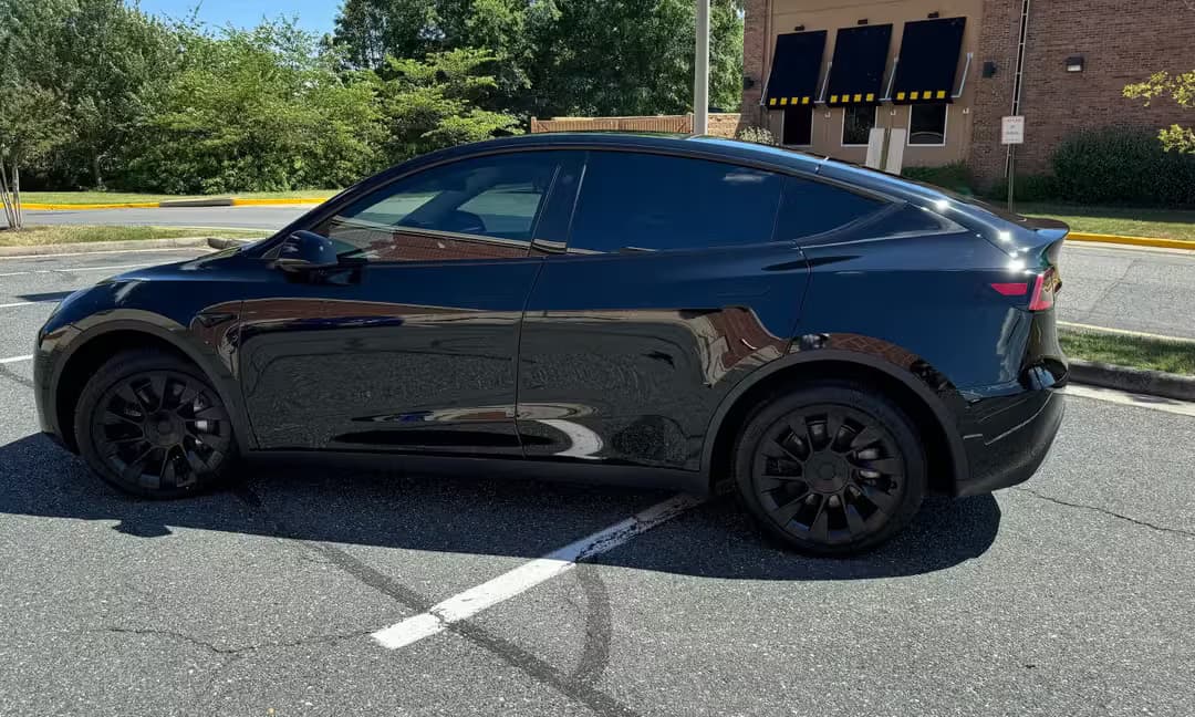 2023 Tesla Model Y Long Range AWD in Solid Black — Side Profile