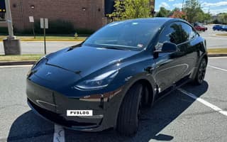 2023 Tesla Model Y Long Range AWD in Solid Black — Front Left