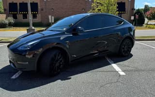 2023 Tesla Model Y Long Range AWD in Solid Black — Side Rear