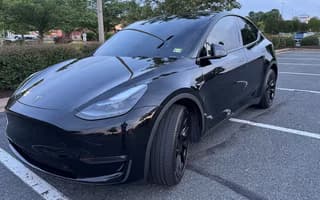 2023 Tesla Model Y Long Range AWD in Solid Black — Front Right