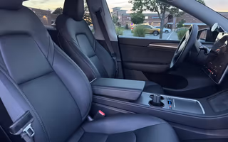 2023 Tesla Model Y Long Range AWD in Solid Black — Front Seats