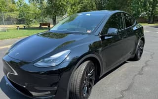 2023 Tesla Model Y Long Range AWD in Solid Black — Front Left
