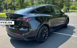 2023 Tesla Model Y Long Range AWD in Solid Black — Rear Angle