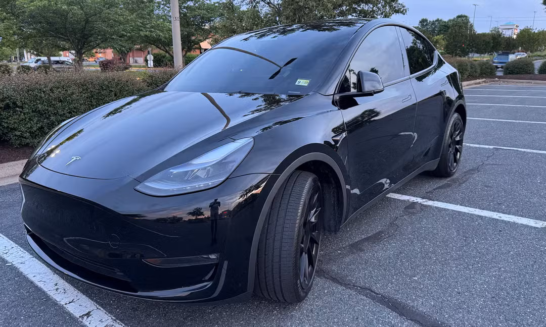 2023 Tesla Model Y Long Range AWD in Solid Black, Front Right